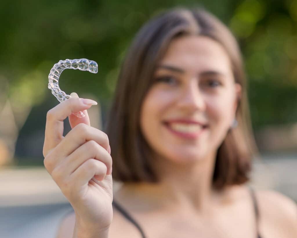 Out of focus woman holding Invisalign